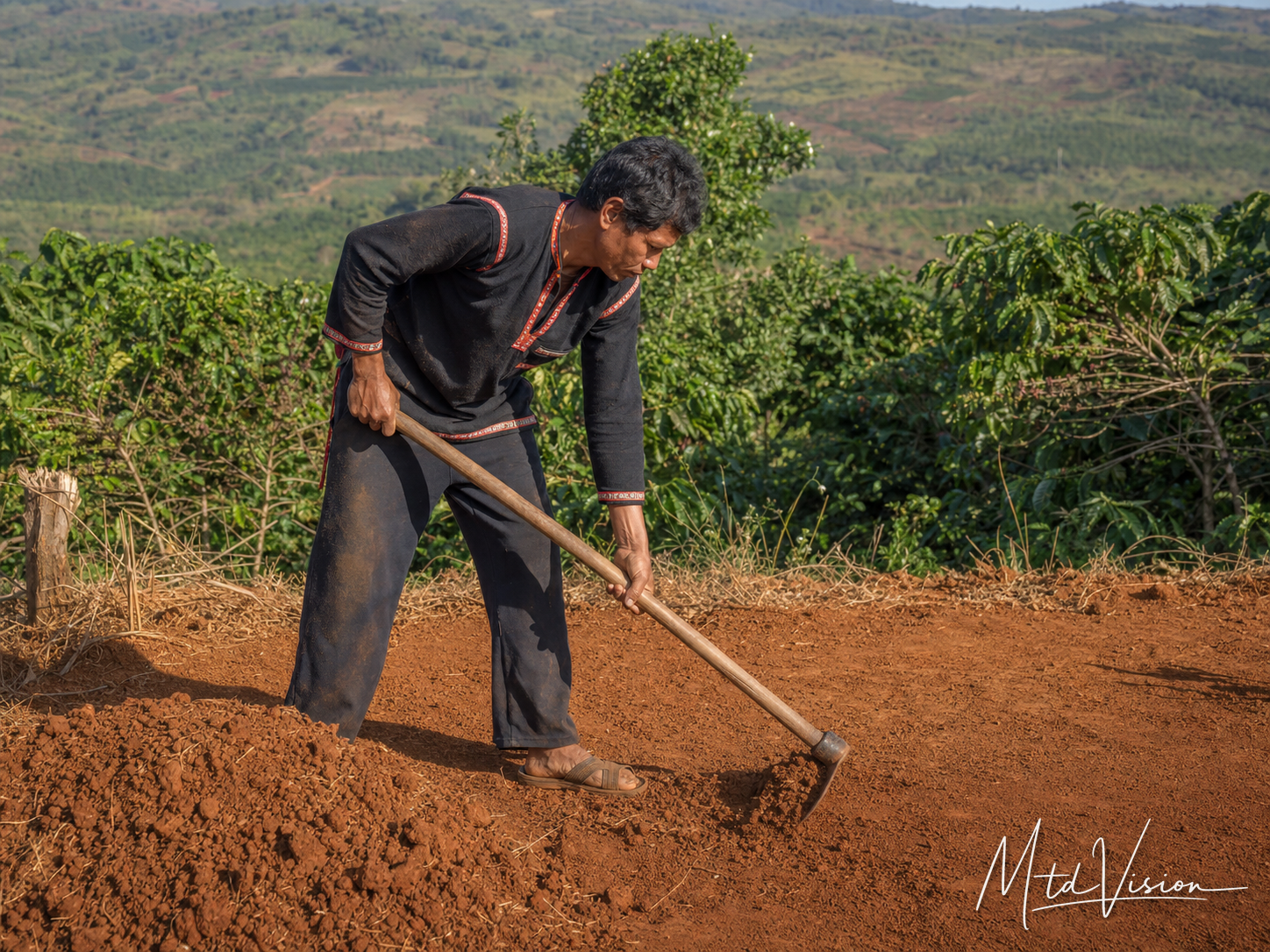 To clear, dig, excavate, or level land by hand.